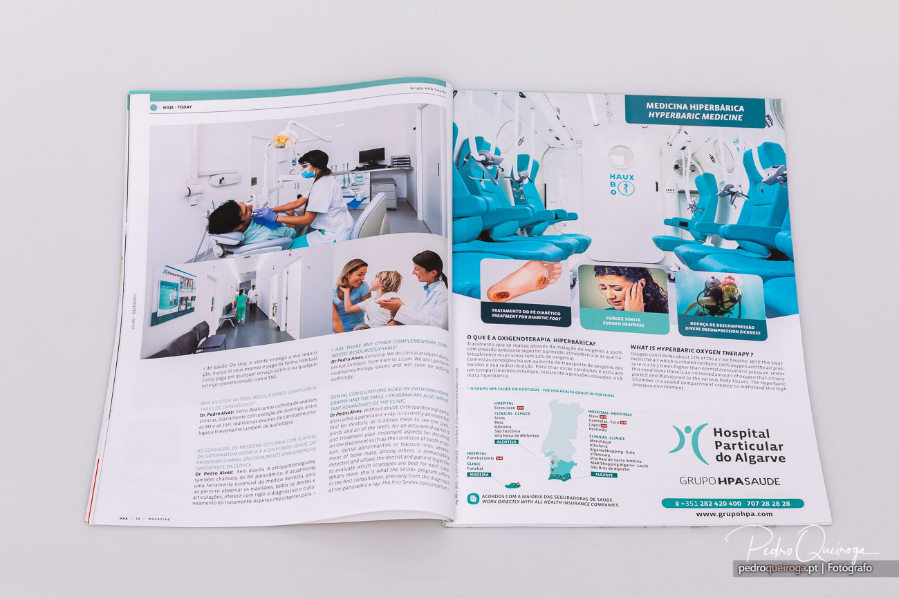 Revista aberta a mostrar publicidade do Hospital Particular do Algarve sobre medicina hiperbárica e serviços clínicos
