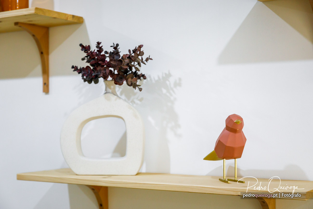 Decoração minimalista com pássaro coral e elementos naturais ideal para valorizar imóveis modernos